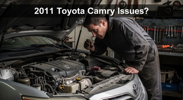 Mechanic inspecting engine bay of a 2011 Toyota Camry with hood open in garage, highlighting common 2011 Toyota Camry Issues?