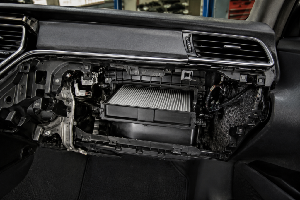 Toyota Camry cabin air filter location shown behind glove box in dashboard cutaway view for easy identification