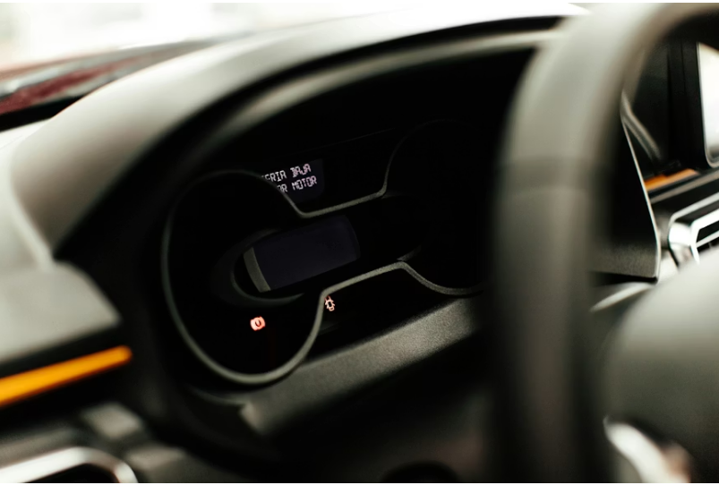Close-up dashboard view showing traction control warning light in Toyota Camry while explaining how to turn on traction control safely