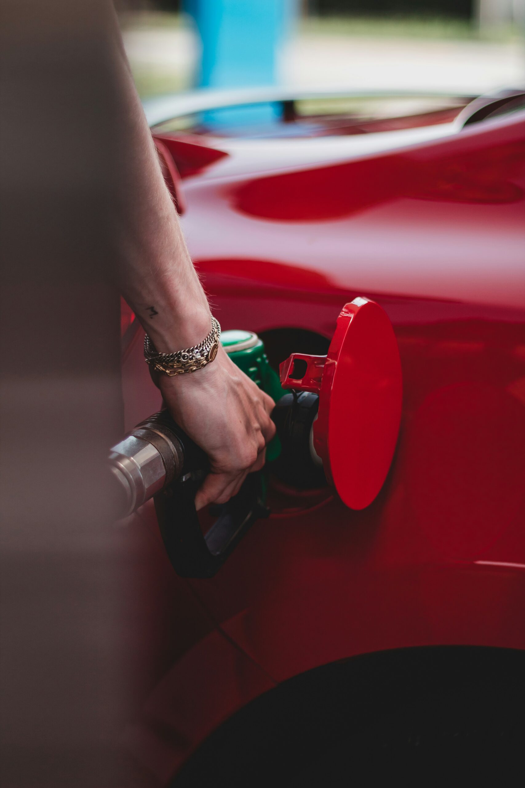 Toyota Camry owner pumping regular 87 octane gas at a fuel station